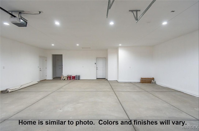 garage with a garage door opener and recessed lighting