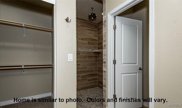 full bathroom with a stall shower and a spacious closet