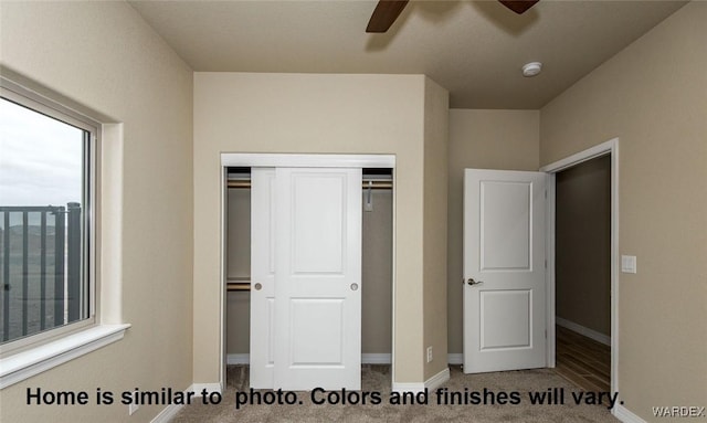 unfurnished bedroom featuring ceiling fan, a closet, carpet, and baseboards