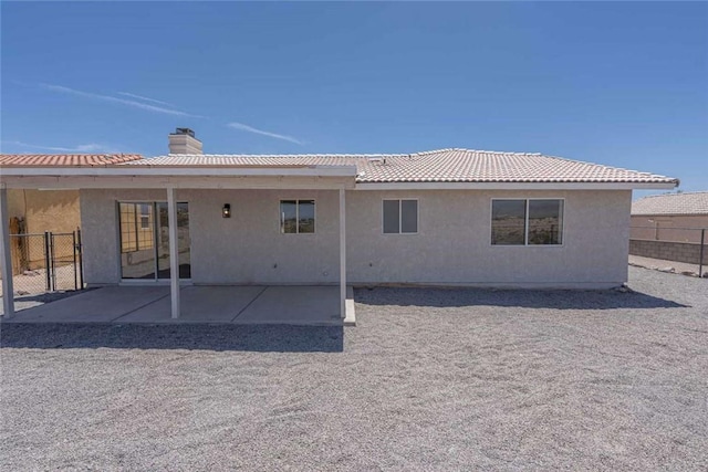 1925 E Ln Entrada Pl, Fort Mohave, AZ 86426 - rear view of house with stucco siding, a chimney, a patio, and a tile roof