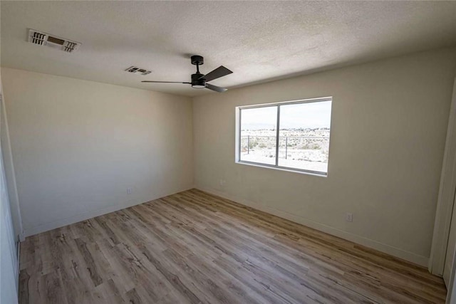 1925 E Ln Entrada Pl, Fort Mohave, AZ 86426 - empty room with ceiling fan, wood finished floors, and a textured ceiling