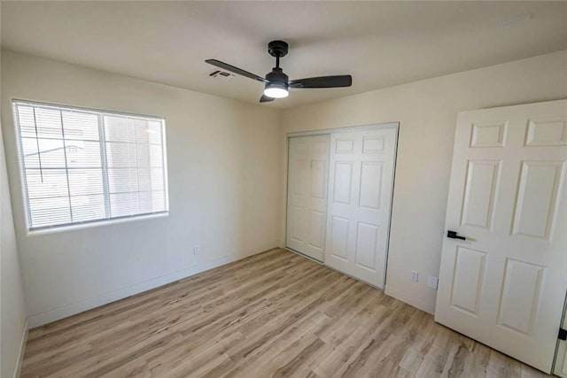 1925 E Ln Entrada Pl, Fort Mohave, AZ 86426 - unfurnished bedroom with light wood-style flooring, a closet, and ceiling fan