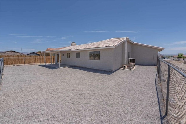 1925 E Ln Entrada Pl, Fort Mohave, AZ 86426 - rear view of property with a fenced backyard, stucco siding, a chimney, and a patio