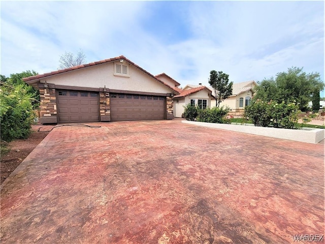 view of front of home with stone siding, concrete driveway, a garage, and stucco siding