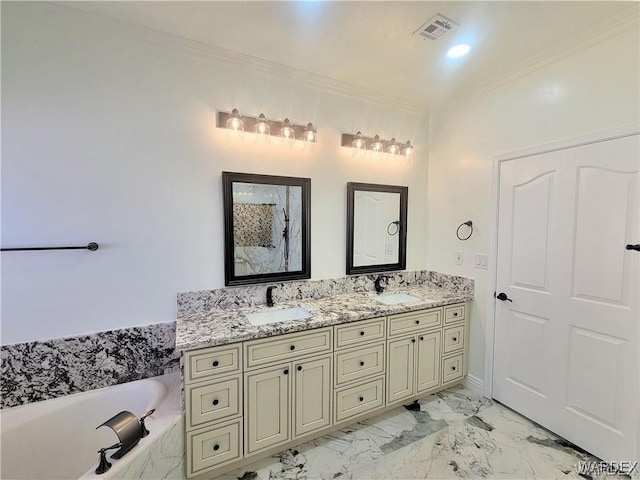 bathroom featuring ornamental molding, visible vents, a sink, and a garden tub