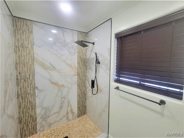 bathroom with a marble finish shower and crown molding