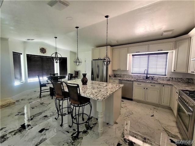 kitchen with a sink, visible vents, vaulted ceiling, marble finish floor, and appliances with stainless steel finishes