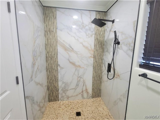 full bathroom featuring ornamental molding and a marble finish shower