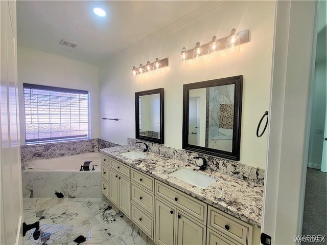 full bath featuring a garden tub, marble finish floor, ornamental molding, and a sink