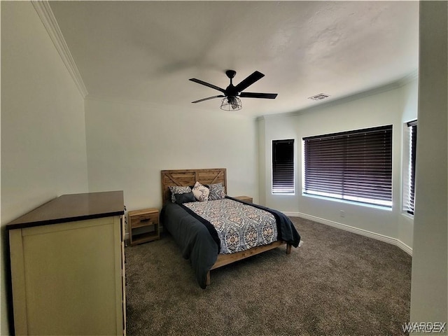 bedroom featuring visible vents, baseboards, a ceiling fan, dark colored carpet, and crown molding