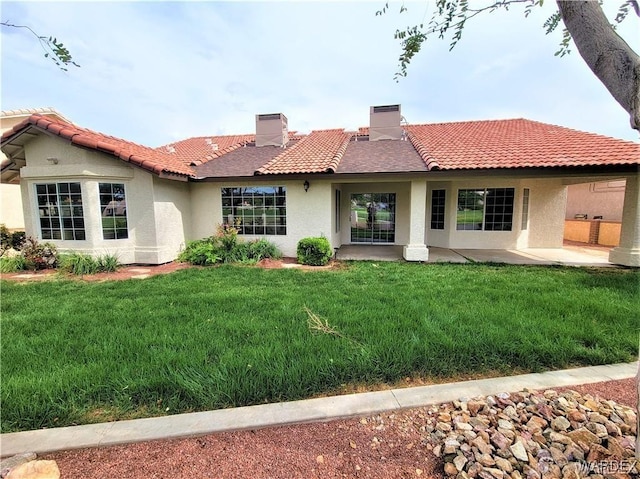 back of property with central AC, a yard, a tiled roof, stucco siding, and a chimney