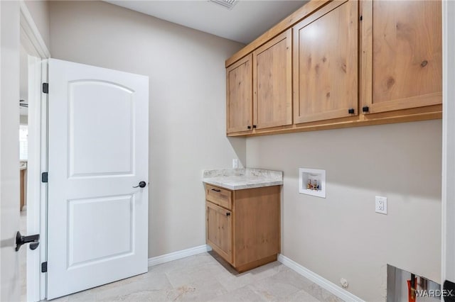 washroom with washer hookup, cabinet space, and baseboards