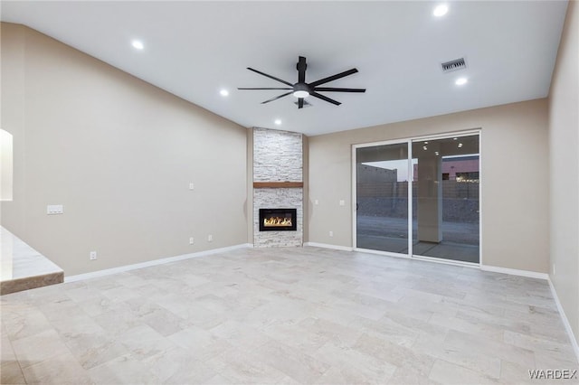 unfurnished living room featuring baseboards, visible vents, a ceiling fan, a stone fireplace, and recessed lighting