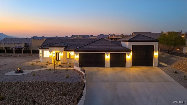 view of front of house with a residential view, driveway, an attached garage, and stucco siding