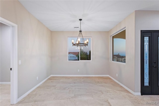 interior space featuring baseboards, visible vents, and a notable chandelier