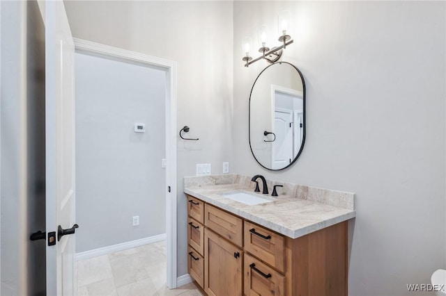 bathroom with baseboards and vanity