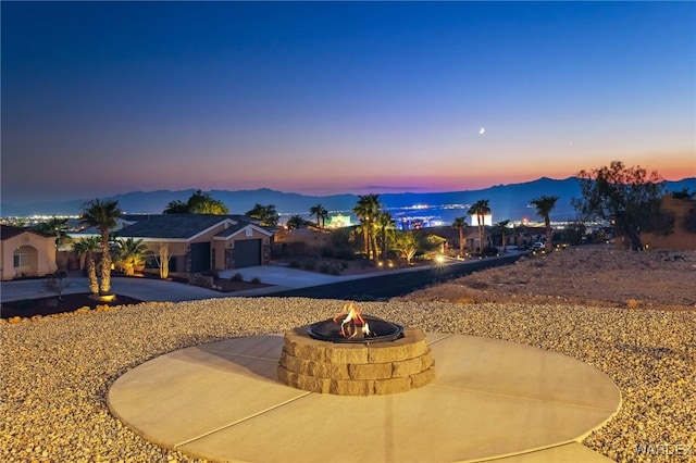 exterior space featuring a fire pit, a patio, and a mountain view