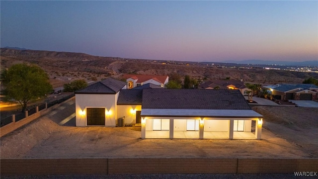 view of front of house with central AC unit and stucco siding