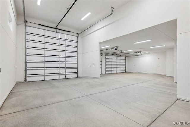 garage with baseboards and a garage door opener