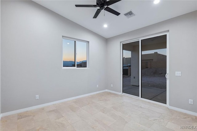 spare room featuring baseboards, visible vents, a ceiling fan, vaulted ceiling, and recessed lighting