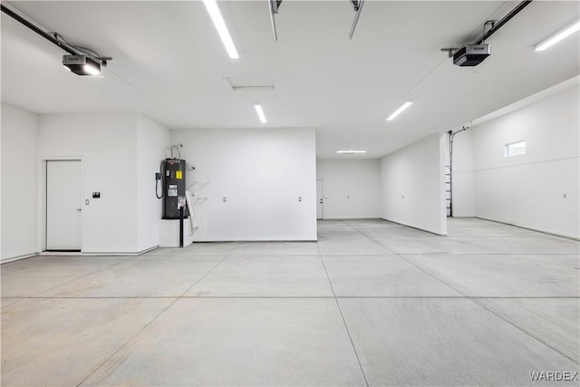 parking garage with electric water heater and a garage door opener