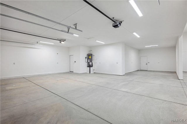 parking garage featuring water heater and a garage door opener