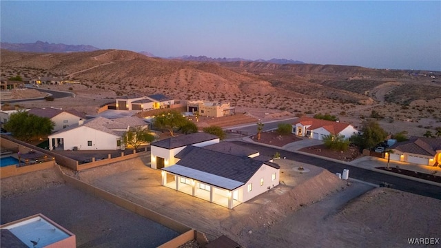 aerial view at dusk with a residential view and a mountain view