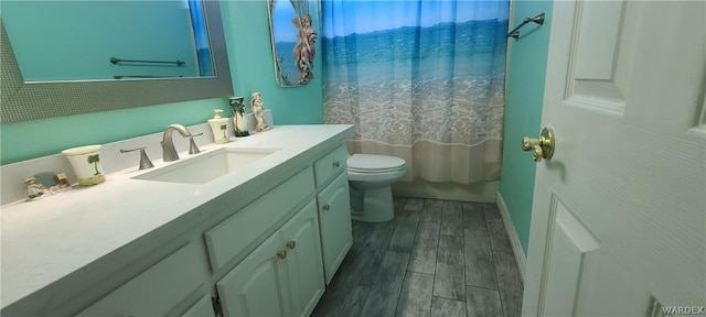 full bathroom with toilet, shower / bathtub combination with curtain, wood finished floors, and vanity