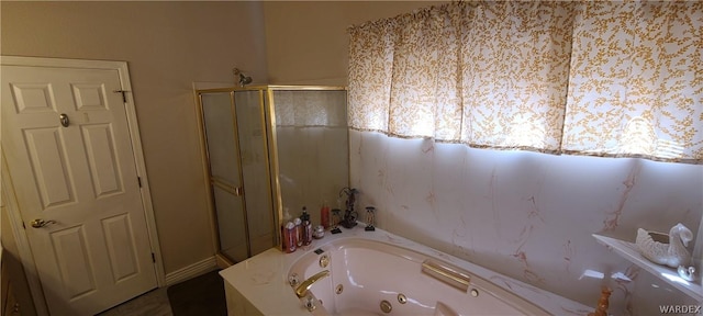 bathroom featuring a tub with jets and a shower stall