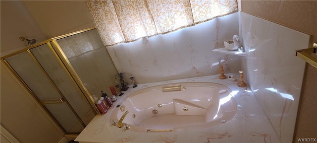 bathroom with a shower stall and a tub with jets