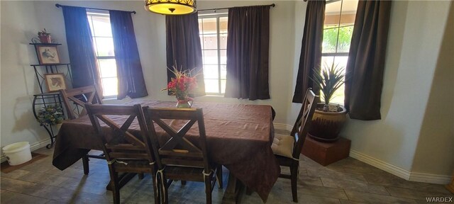 dining space with baseboards and a wealth of natural light