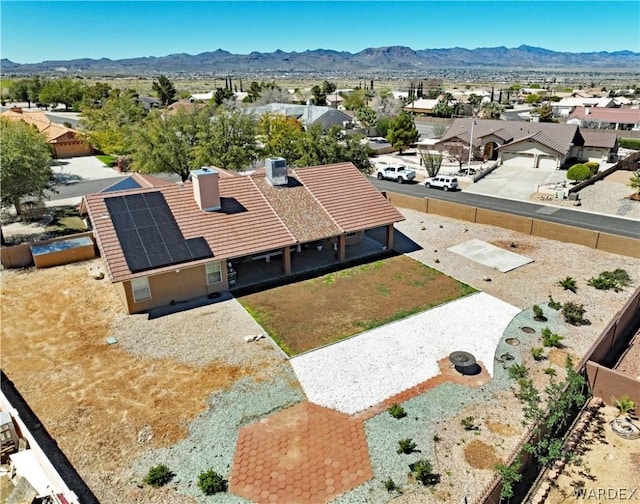 drone / aerial view featuring a residential view and a mountain view