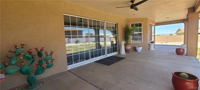 view of patio with ceiling fan and fence