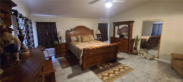 bedroom with lofted ceiling, light wood-style flooring, baseboards, and ceiling fan