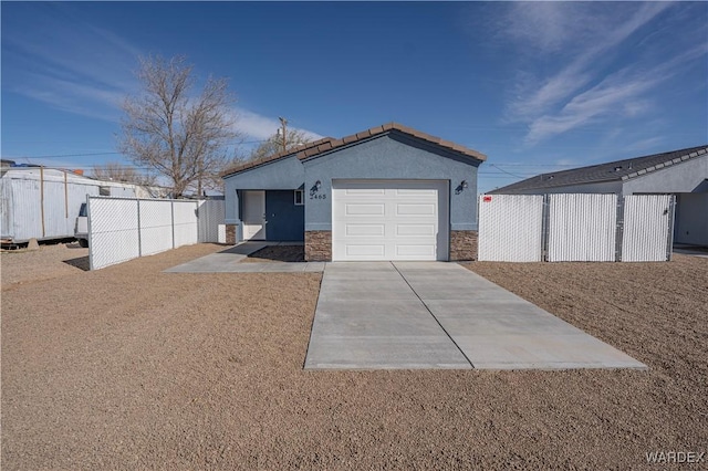 garage with driveway and fence