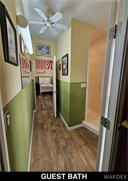 hall with dark wood-type flooring and baseboards