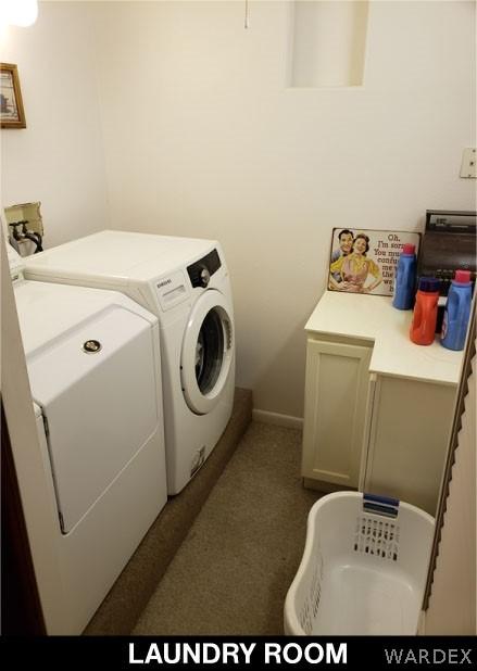 laundry room featuring washing machine and dryer and cabinet space