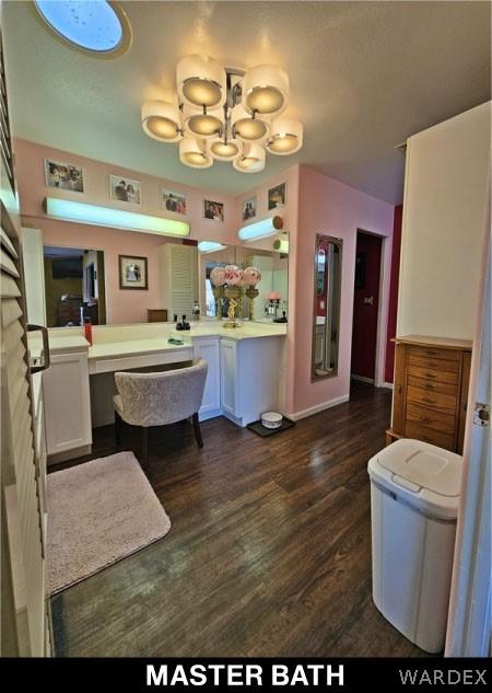 interior space featuring an inviting chandelier, baseboards, and wood finished floors