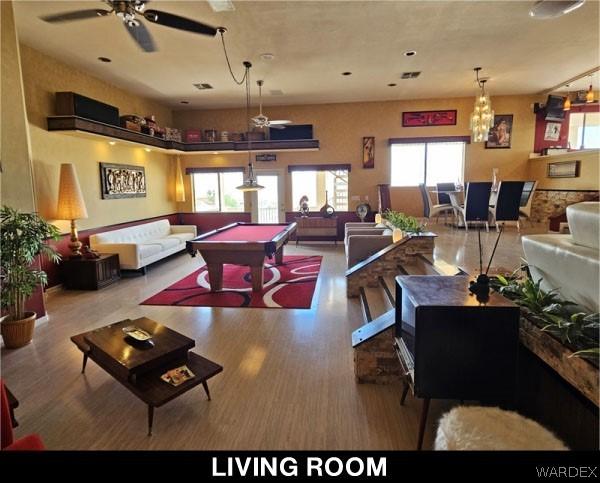 game room with pool table, wood finished floors, and a ceiling fan