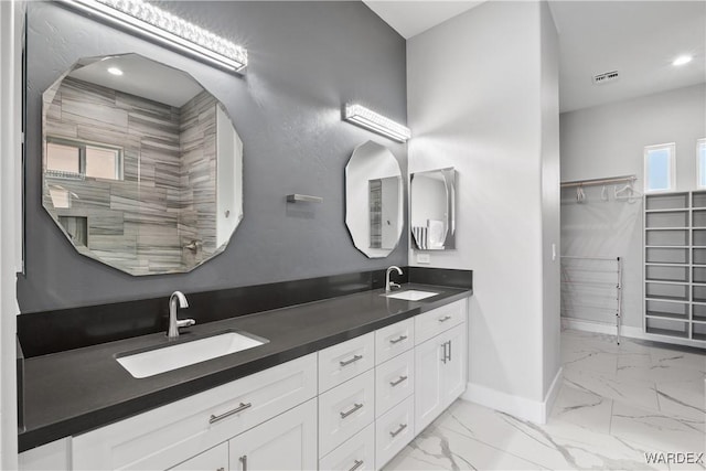 full bathroom featuring marble finish floor, a sink, visible vents, and baseboards