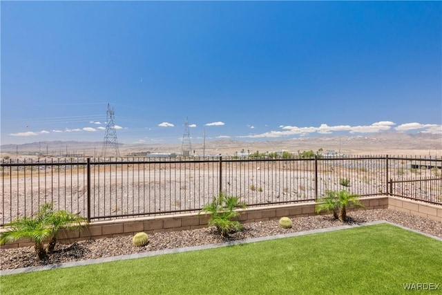 view of yard featuring a fenced backyard and a mountain view