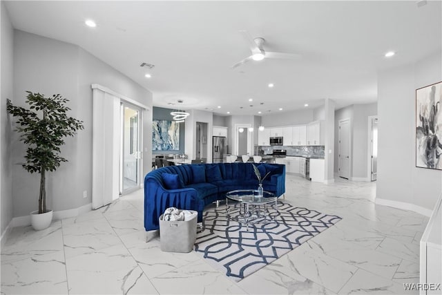 living area featuring baseboards, visible vents, and recessed lighting