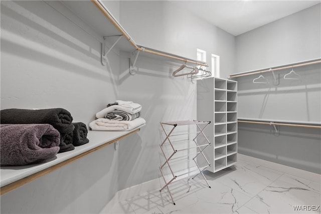 spacious closet with marble finish floor