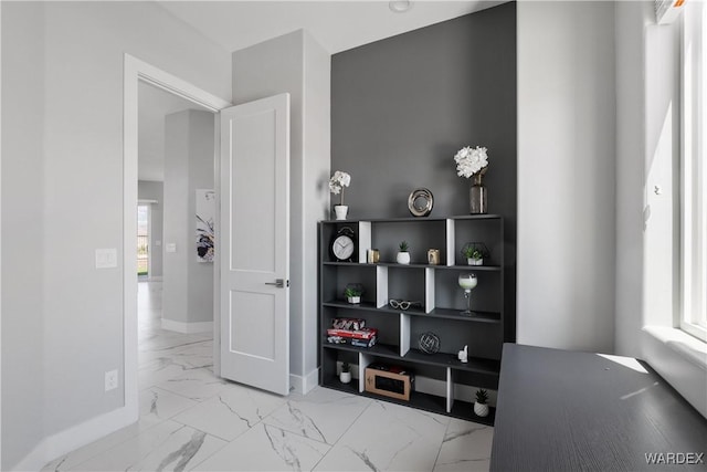 hallway with marble finish floor and baseboards