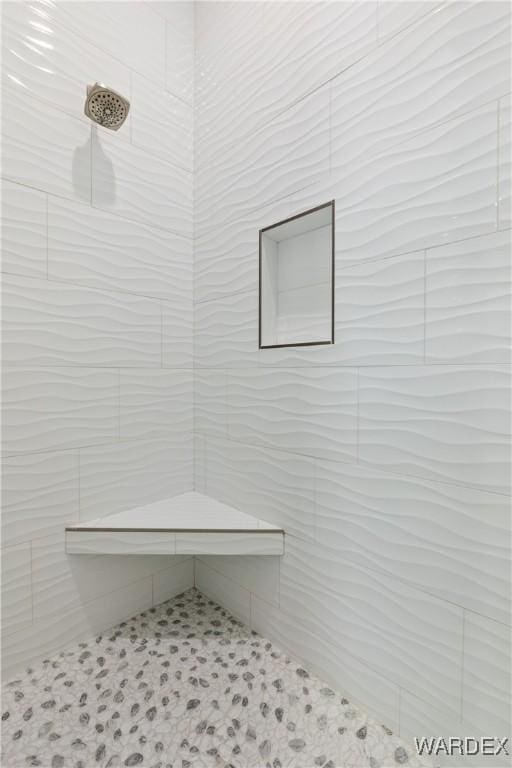 bathroom with tiled shower