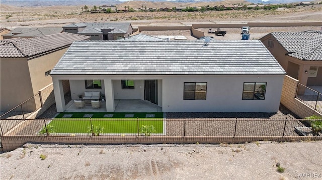 back of house with a patio area, a fenced backyard, and stucco siding