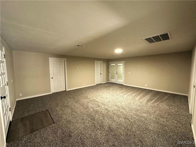 unfurnished room featuring dark carpet, baseboards, visible vents, and recessed lighting