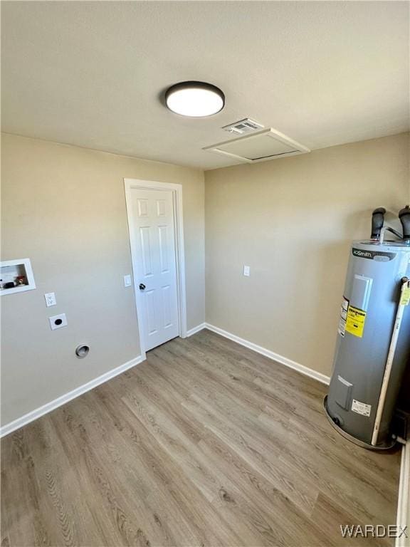 clothes washing area featuring electric water heater, hookup for a washing machine, wood finished floors, electric dryer hookup, and laundry area