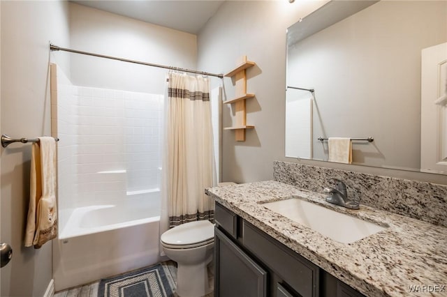 bathroom featuring toilet, shower / bath combo with shower curtain, and vanity