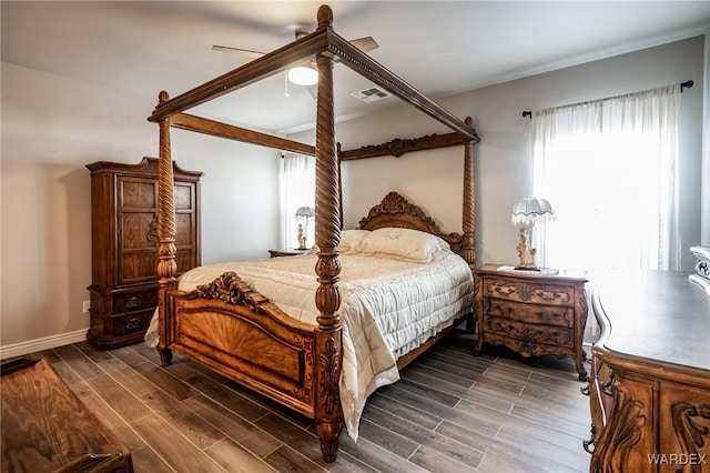 bedroom with baseboards, visible vents, a ceiling fan, and wood finish floors